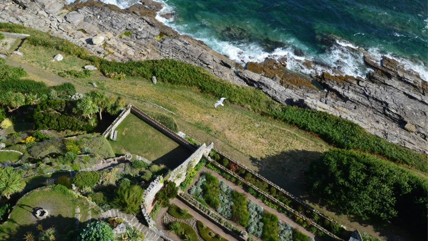 an aerial s of a grassy area near the beach