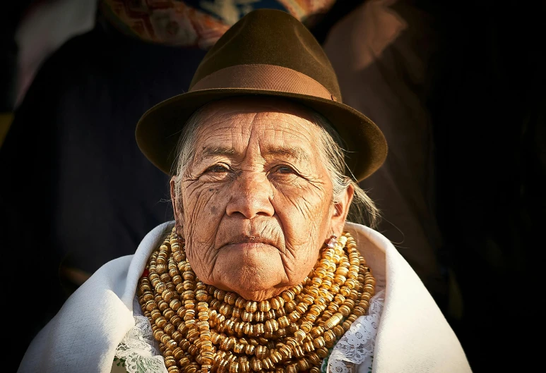 an old woman with long beads and a hat on her head