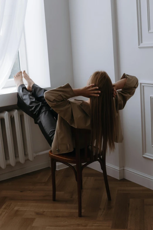 a woman laying back on a chair with her arms wrapped around herself