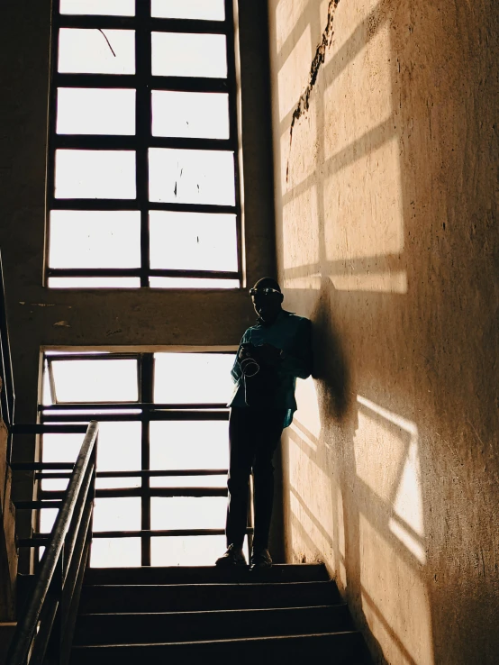 a man is standing at the bottom of stairs