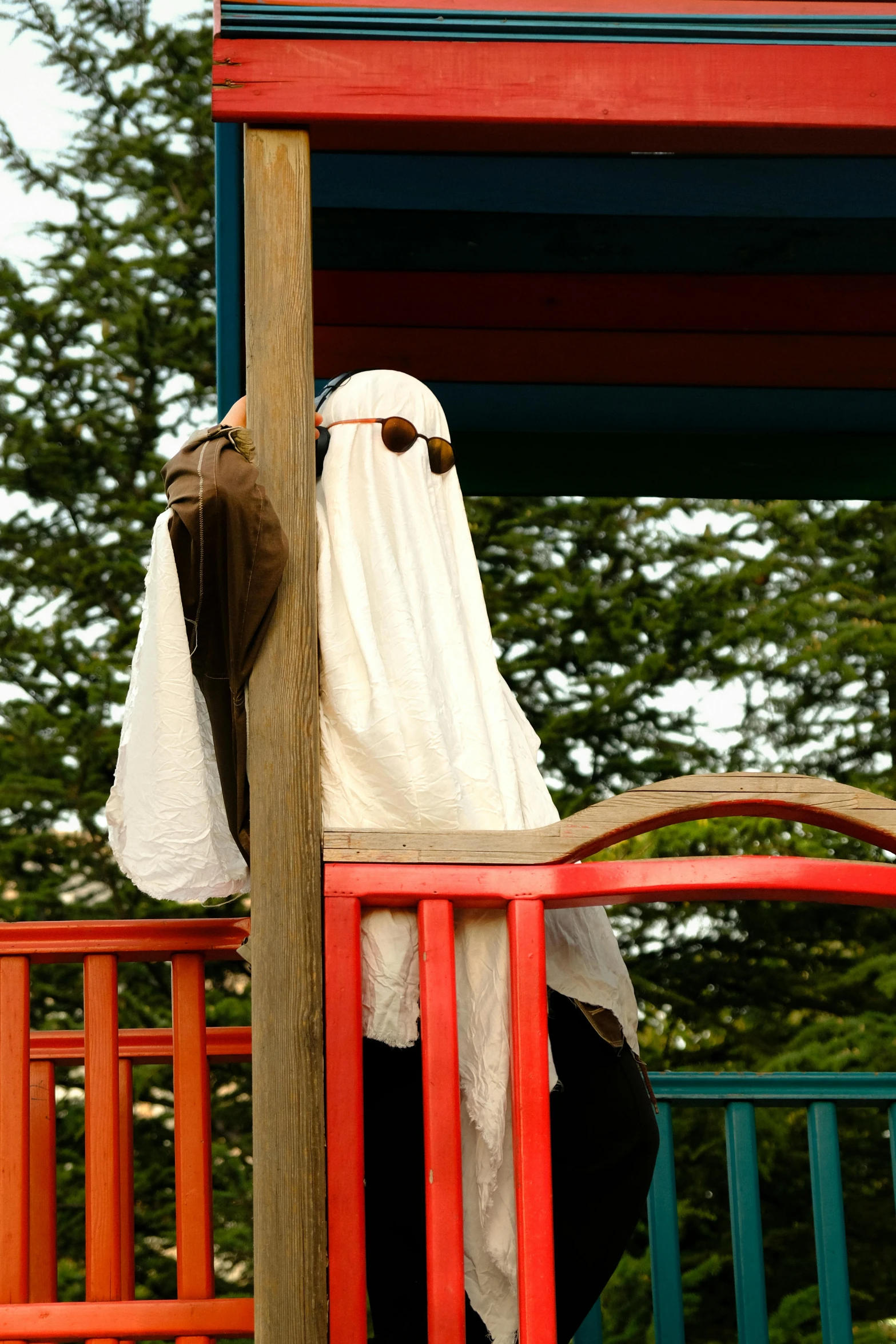 a person in a white towel on top of a colorful playground