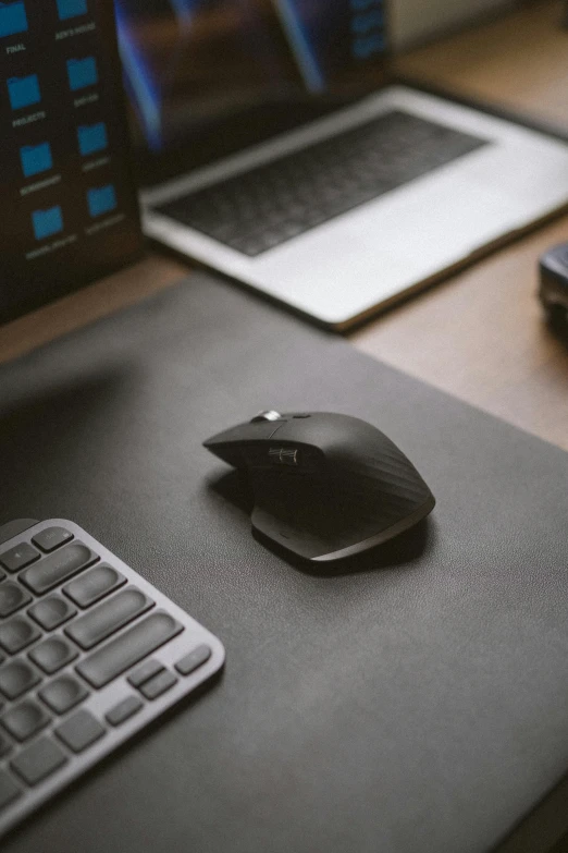 a computer mouse sits on top of a laptop