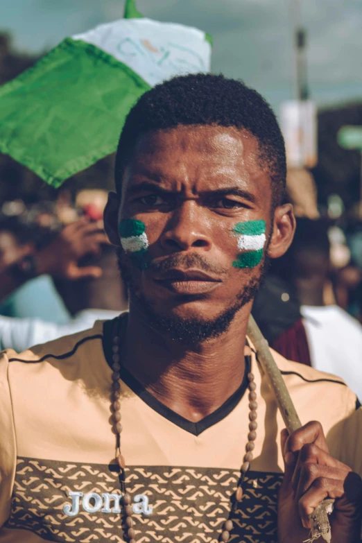 an african man with green face paint on his face