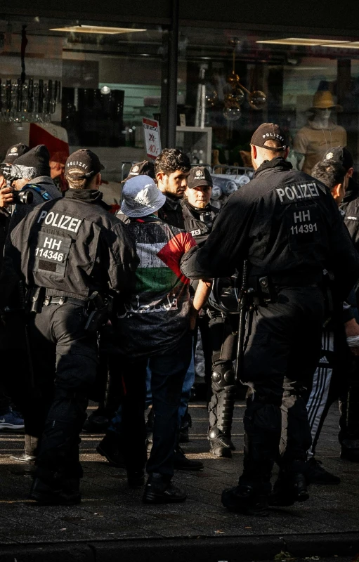 police and protesters gathered together in front of a building