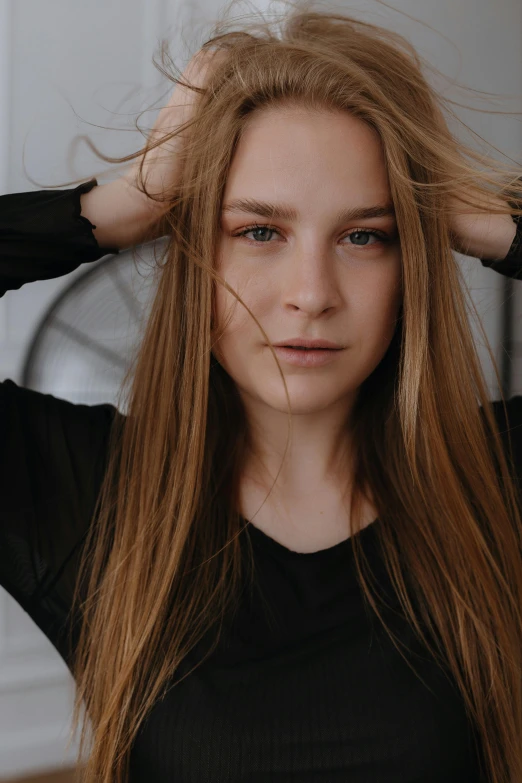 a woman with long hair is shown wearing a black sweater