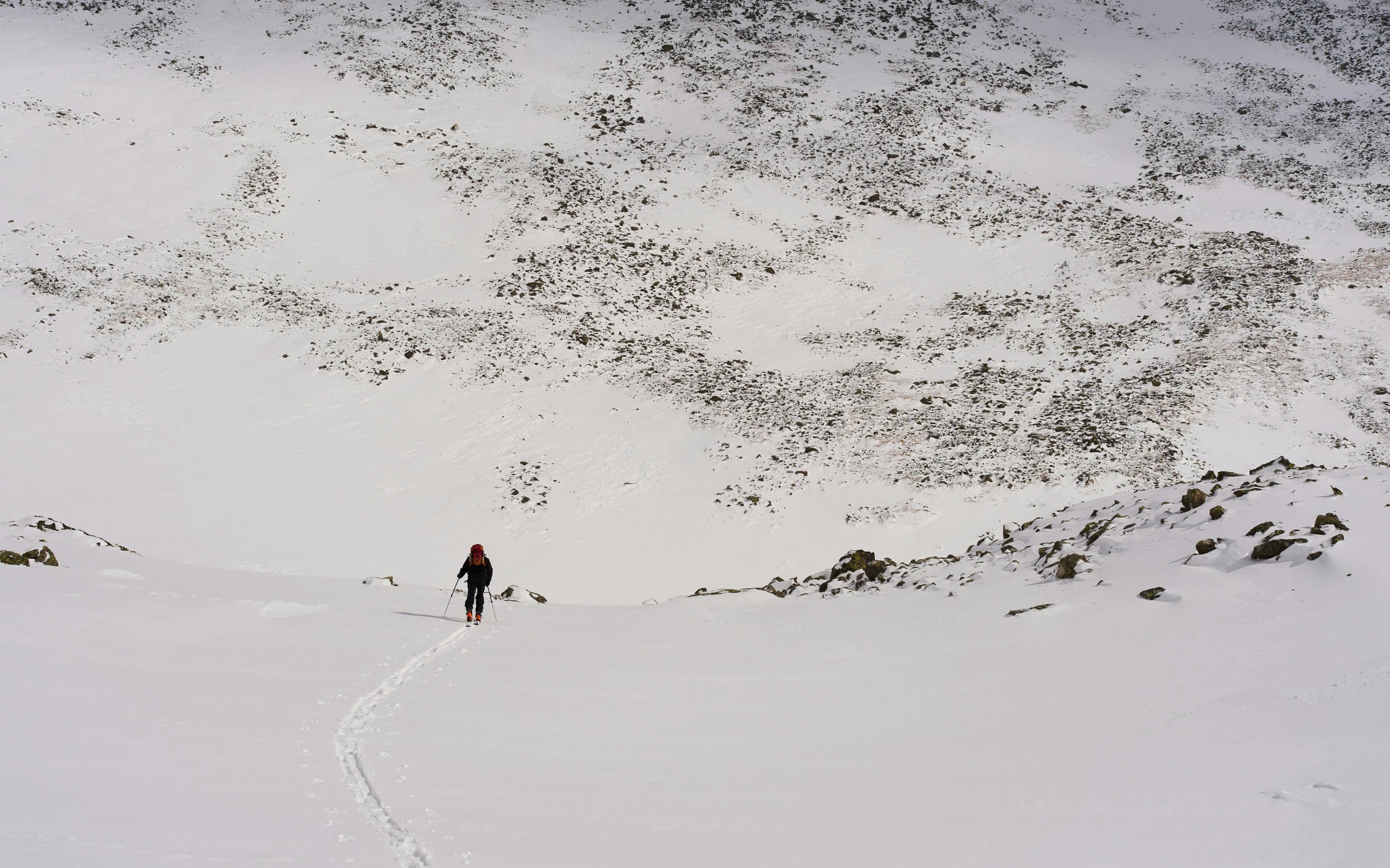 skiers on the slopes of snowy hill during winter