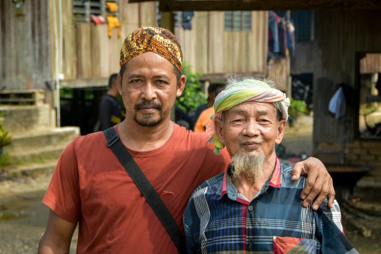 a group of two asian men posing for the camera