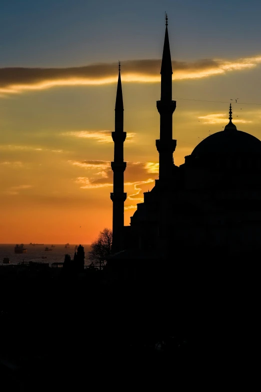 a silhouette of some building at sunset