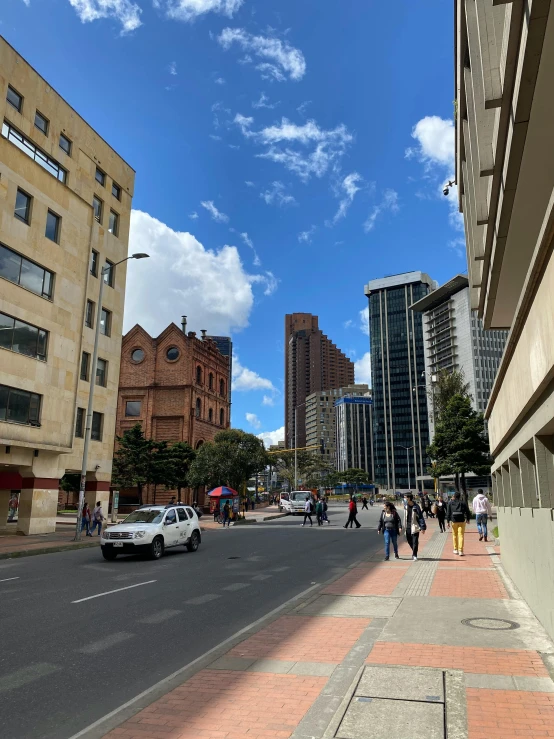 a city filled with lots of tall buildings and people walking on the street