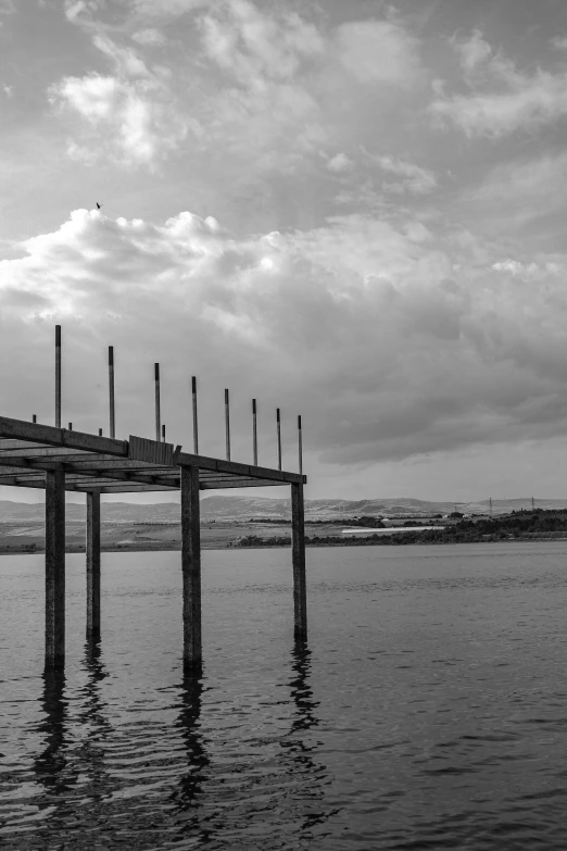 a long pier stretches out into the ocean