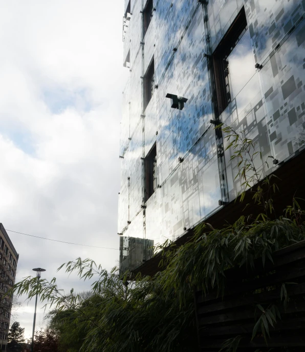 a large building is behind a small garden