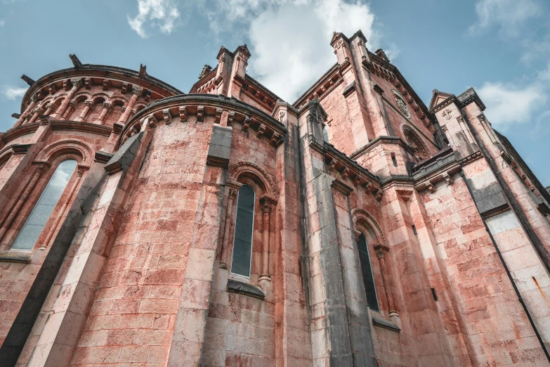 a tall stone building with very ornate windows