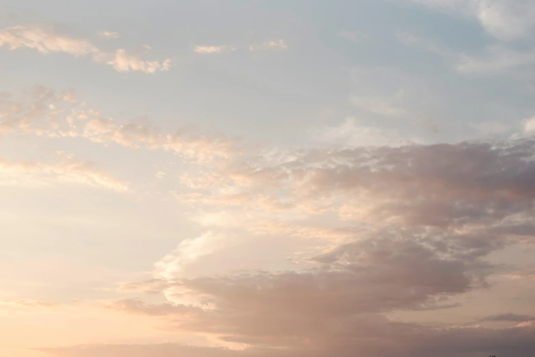 a large kite is in the air, with a lot of clouds above