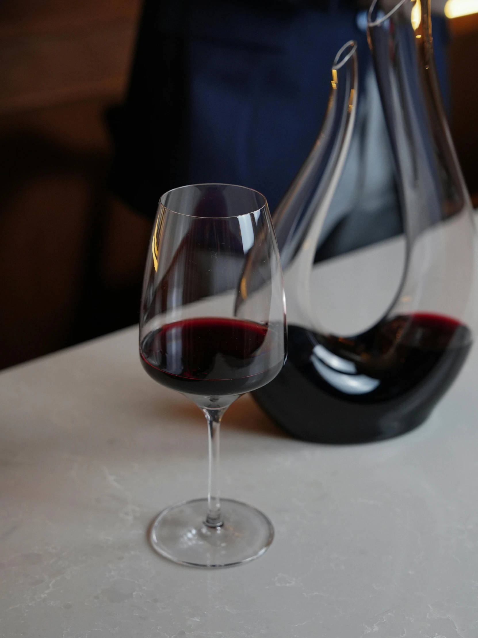 glass and jug sitting on the table ready to be wine tasting