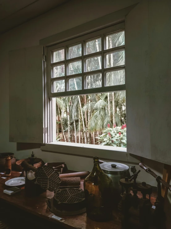 a view of a kitchen and a window that has pot and pans in front of it