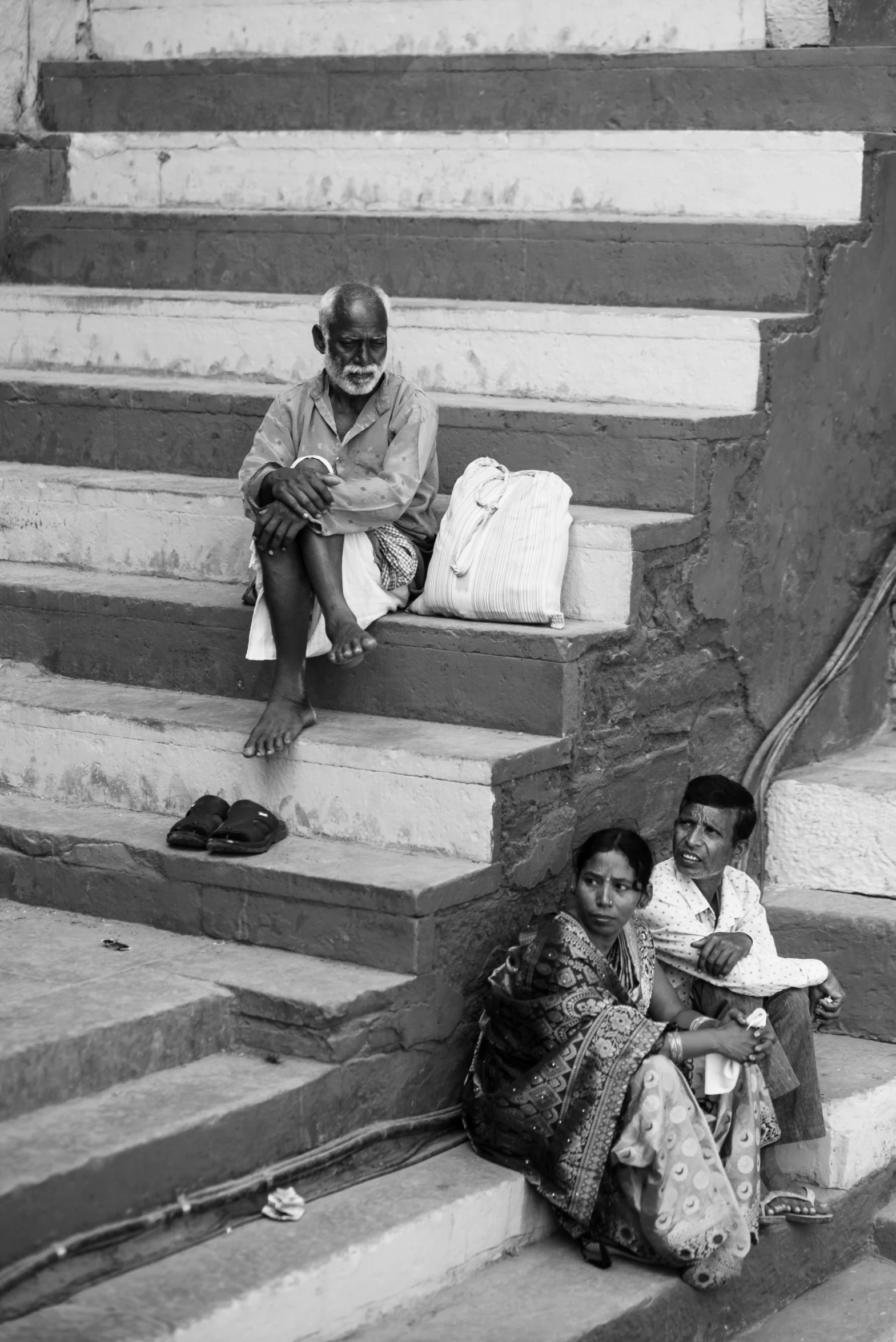 a couple of people sitting on the steps