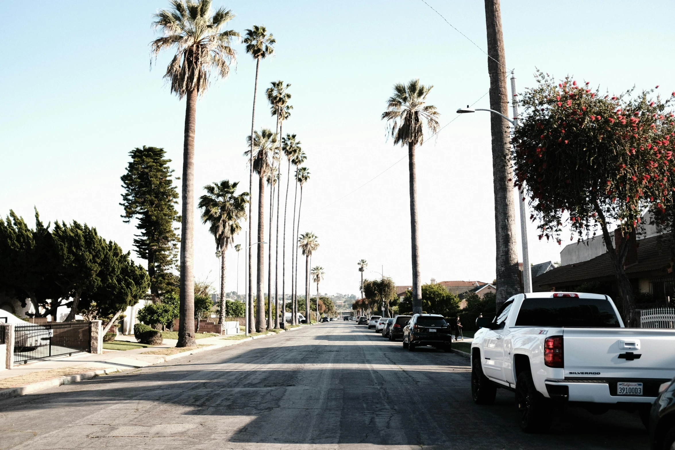 a truck is parked on the side of a quiet street