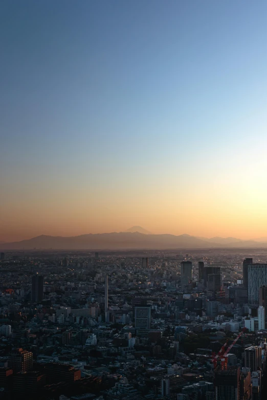 a hazy cityscape with a distant mountain in the distance