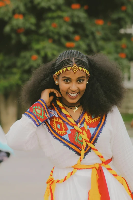 a woman smiles as she poses for the camera