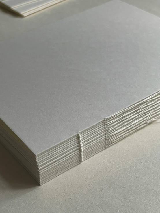 several sheets of paper are stacked together on a table
