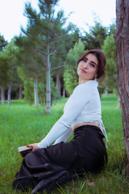 a woman is laying down in the grass