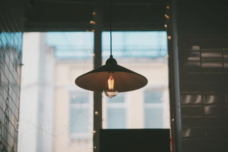 a glass light hanging above a wall in a room