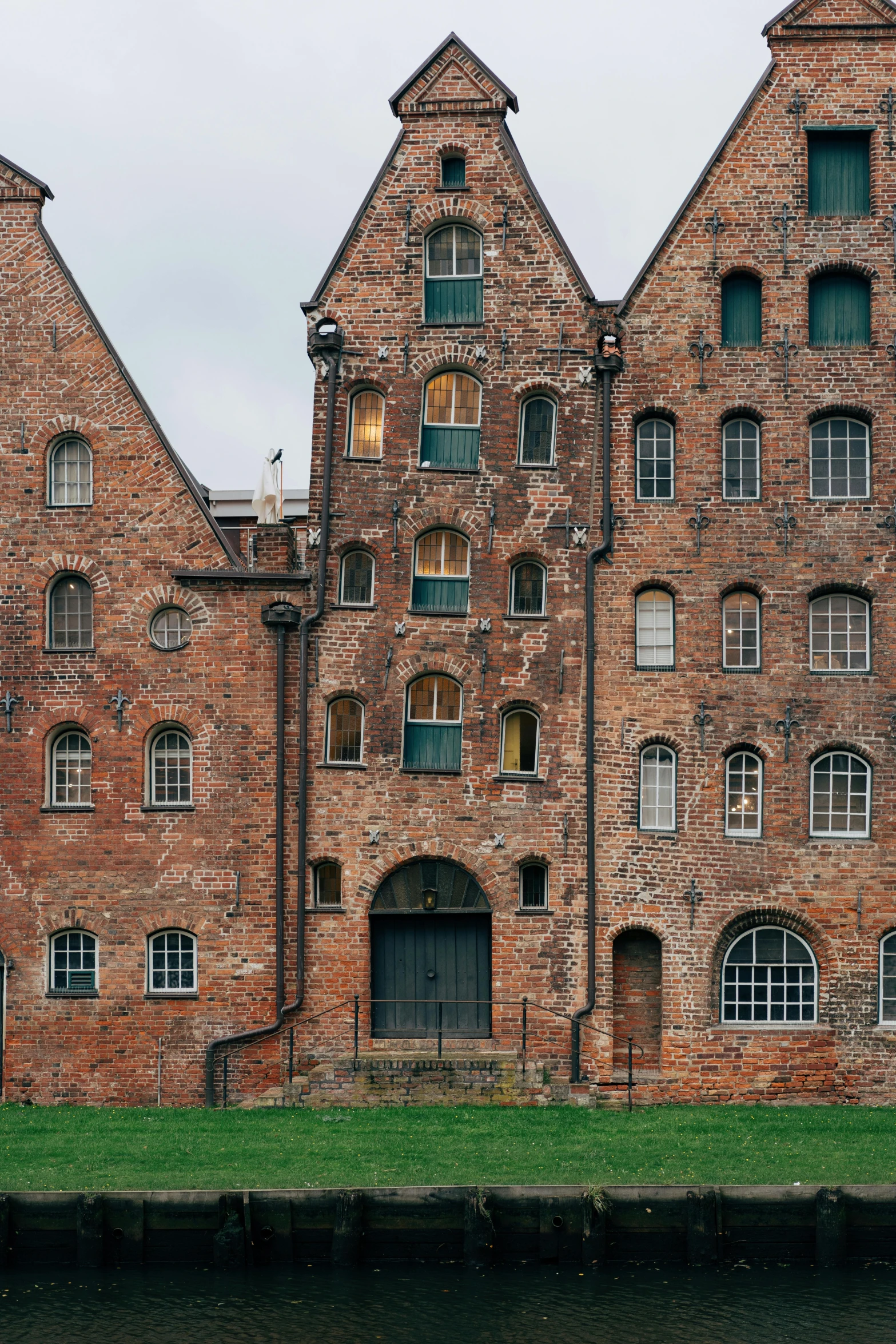 a large brick building is shown next to a body of water