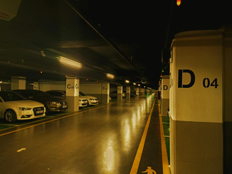 there is a long empty parking lot with parked cars