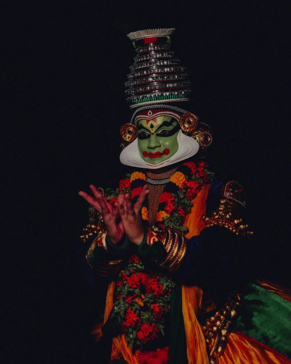 a male entertainer wearing green and gold costume