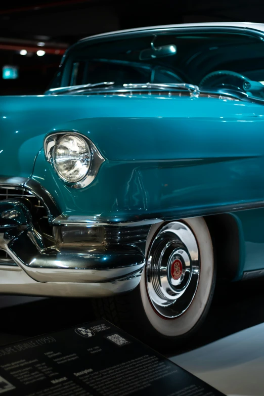 an old and new vintage car on display in a museum