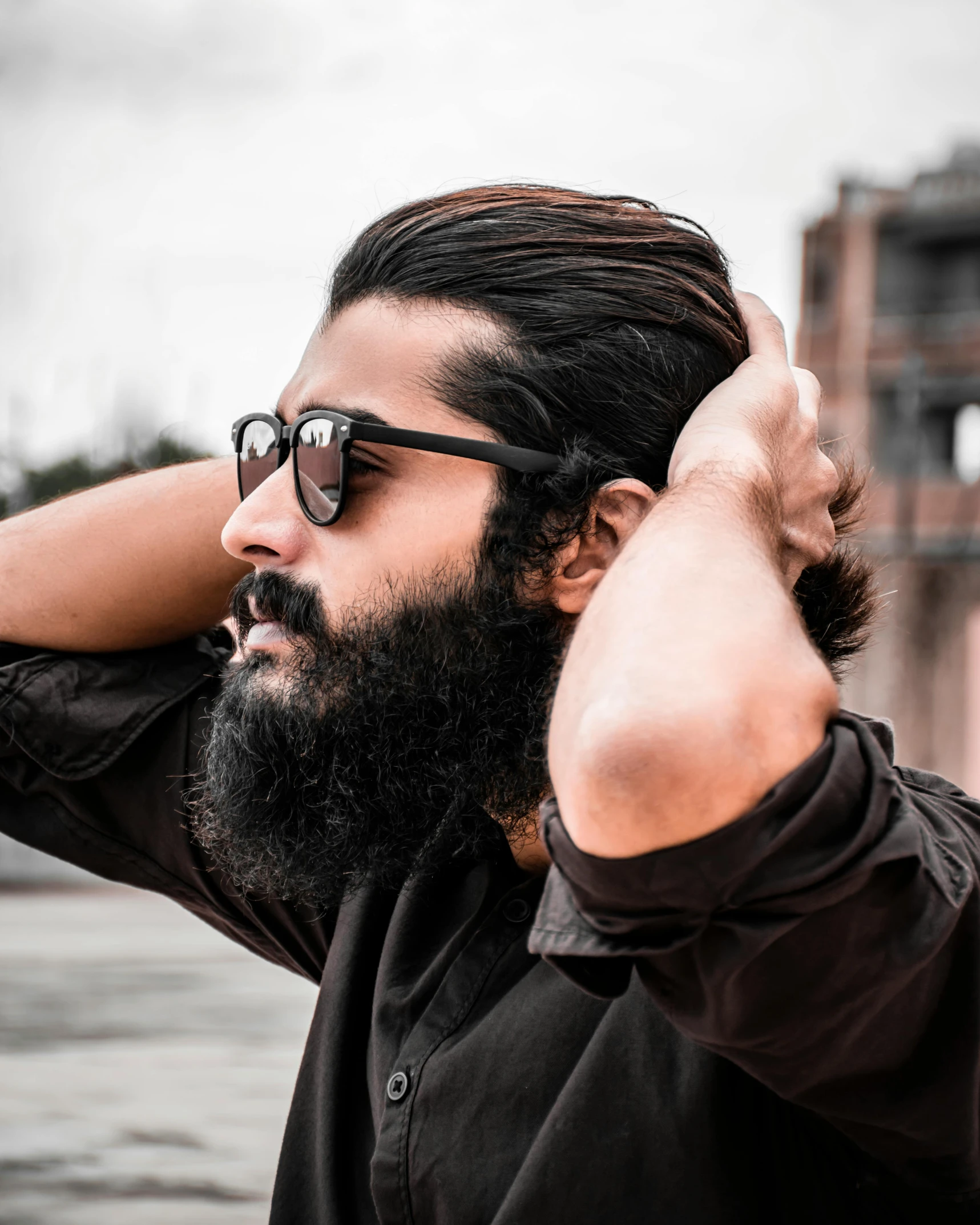 a man is getting his hair pulled back with a beard