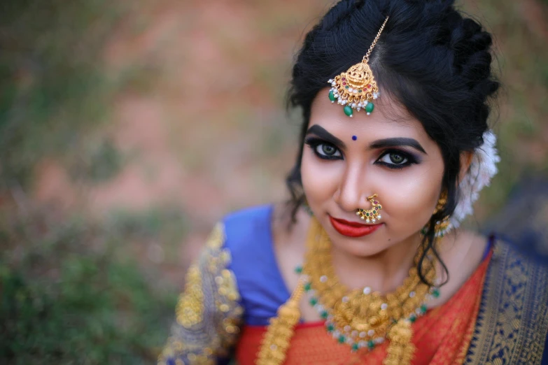 a woman wearing a colorful outfit and nose jewelry