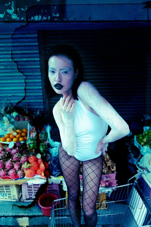 a woman in fishnet stockings is standing in a market