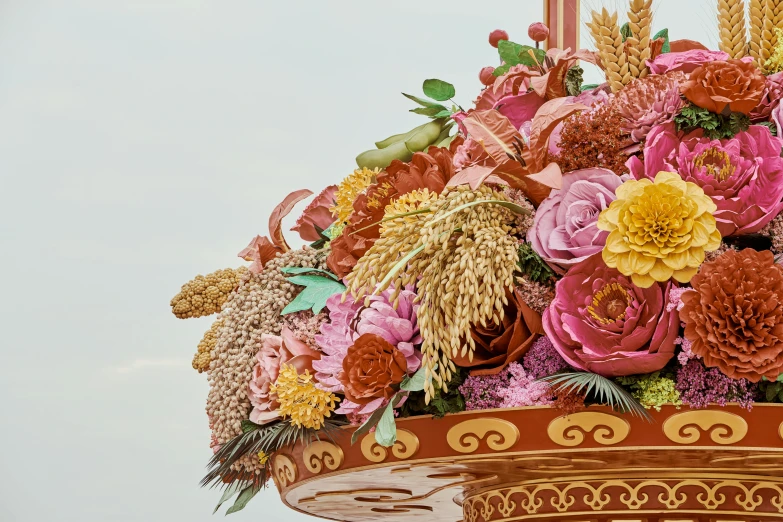 a large arrangement of flowers is sitting on top of a vase