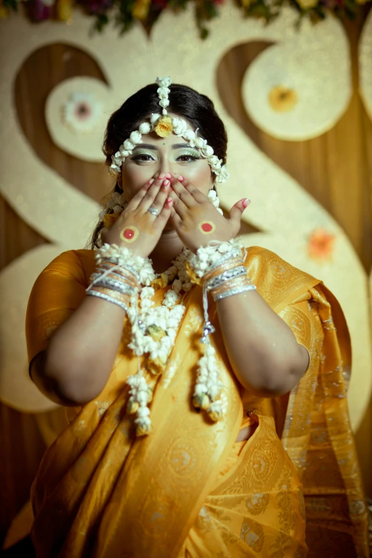 a woman with face paint holding her hands in front of her face