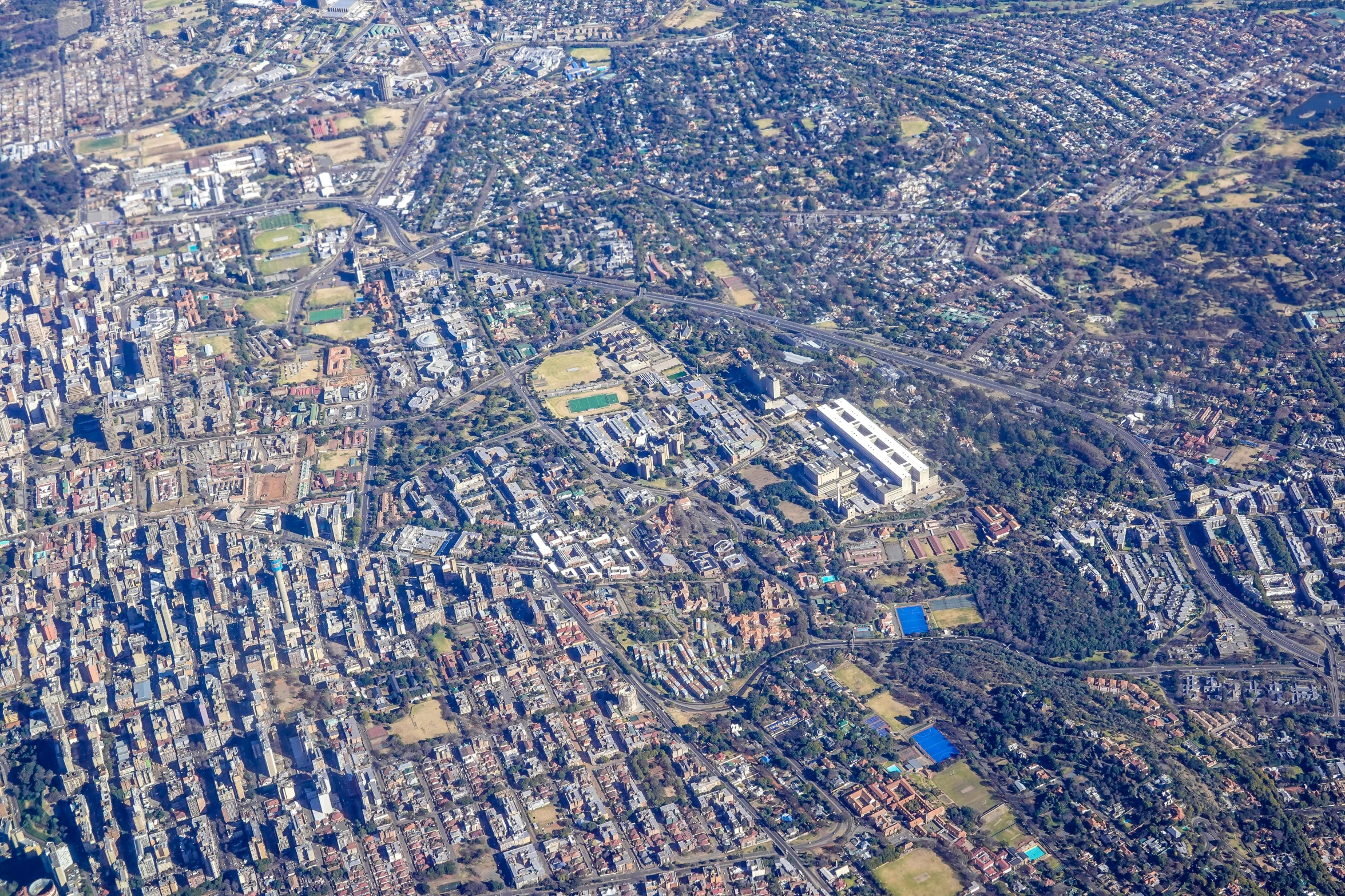 the city as seen from an airplane over a body of water