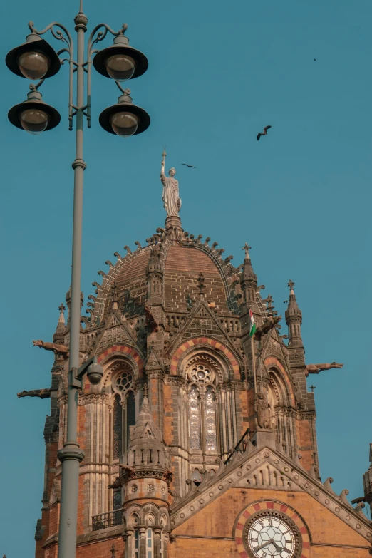 a closeup of a building with a large clock and street lights