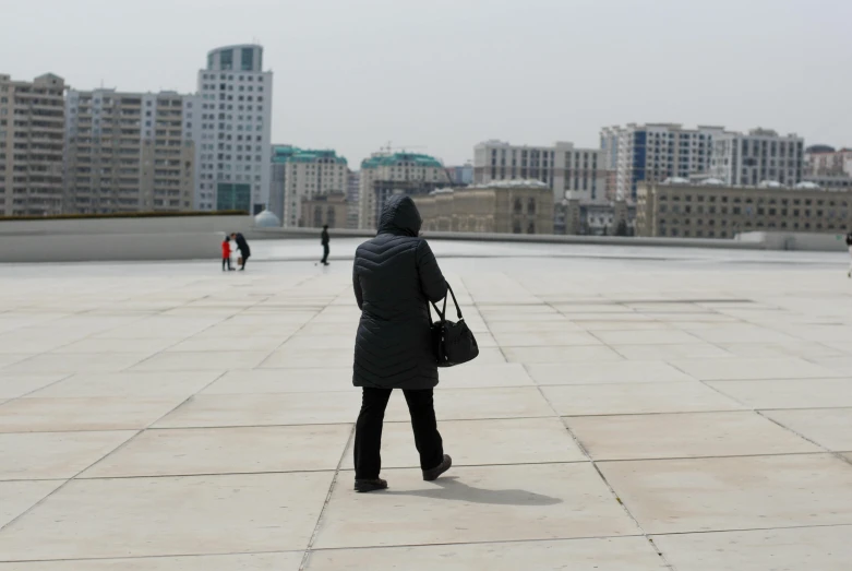 a person with a backpack looking down at buildings