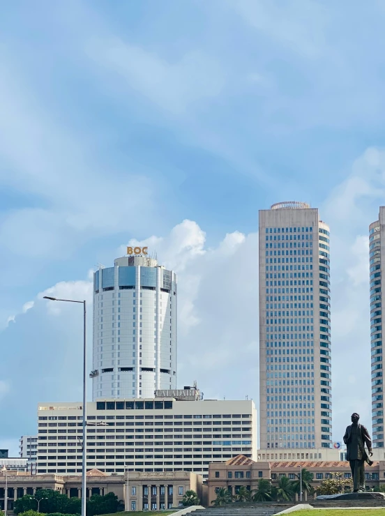 buildings in a city near a highway and the statue of an eagle