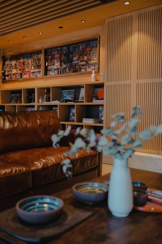 a leather couch with bowl of bowls on the table