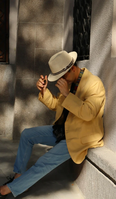 the man is sitting on a concrete step smoking