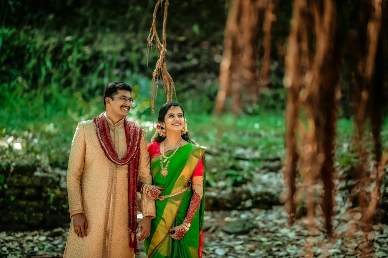 a man and a woman in colorful attire smiling at each other