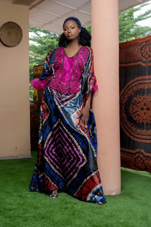 a woman poses for a po in a colorful outfit