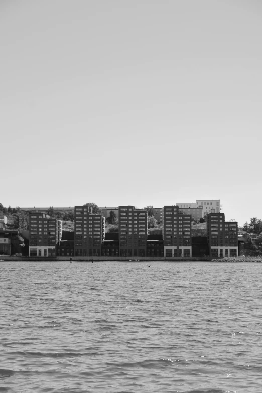 a large ship sailing down a river next to a tall building