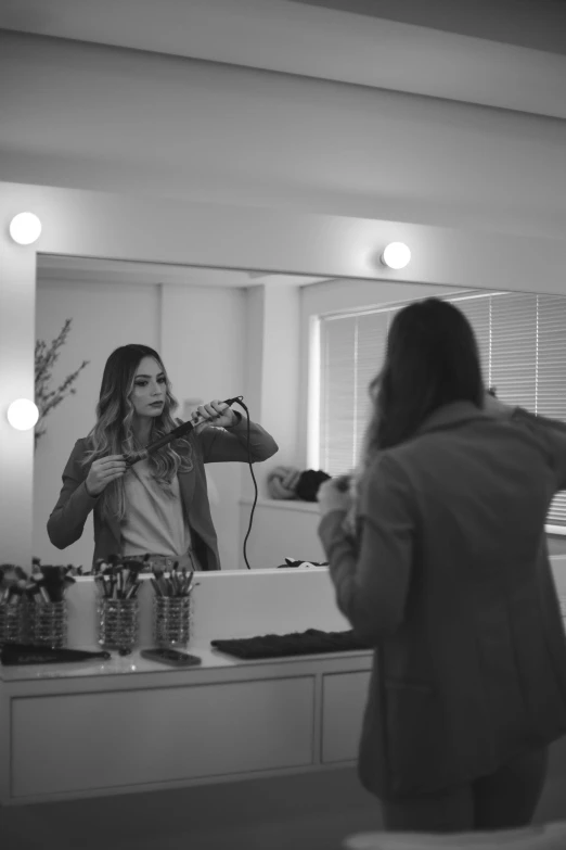 a woman is taking a po of herself in a mirror