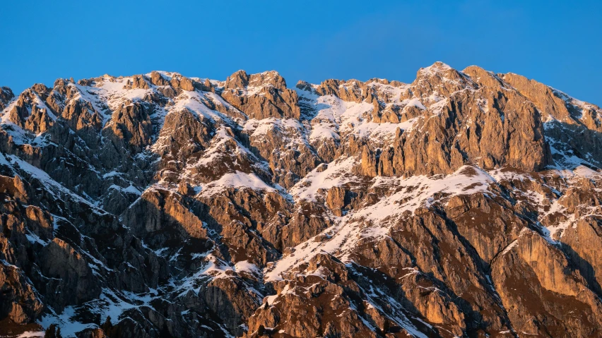 the top of a snowy mountain in the sun