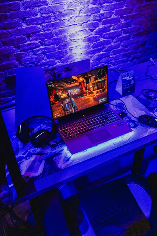 a gaming desk with two laptop computers on it