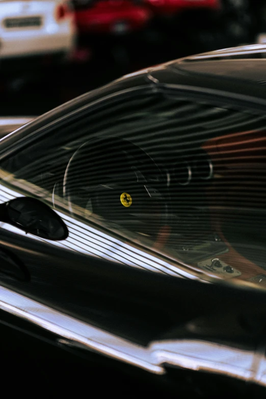 two cats sitting inside a car looking out the window