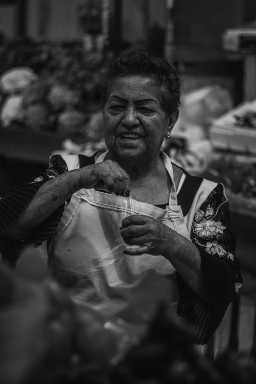 the woman is selling food at the stand