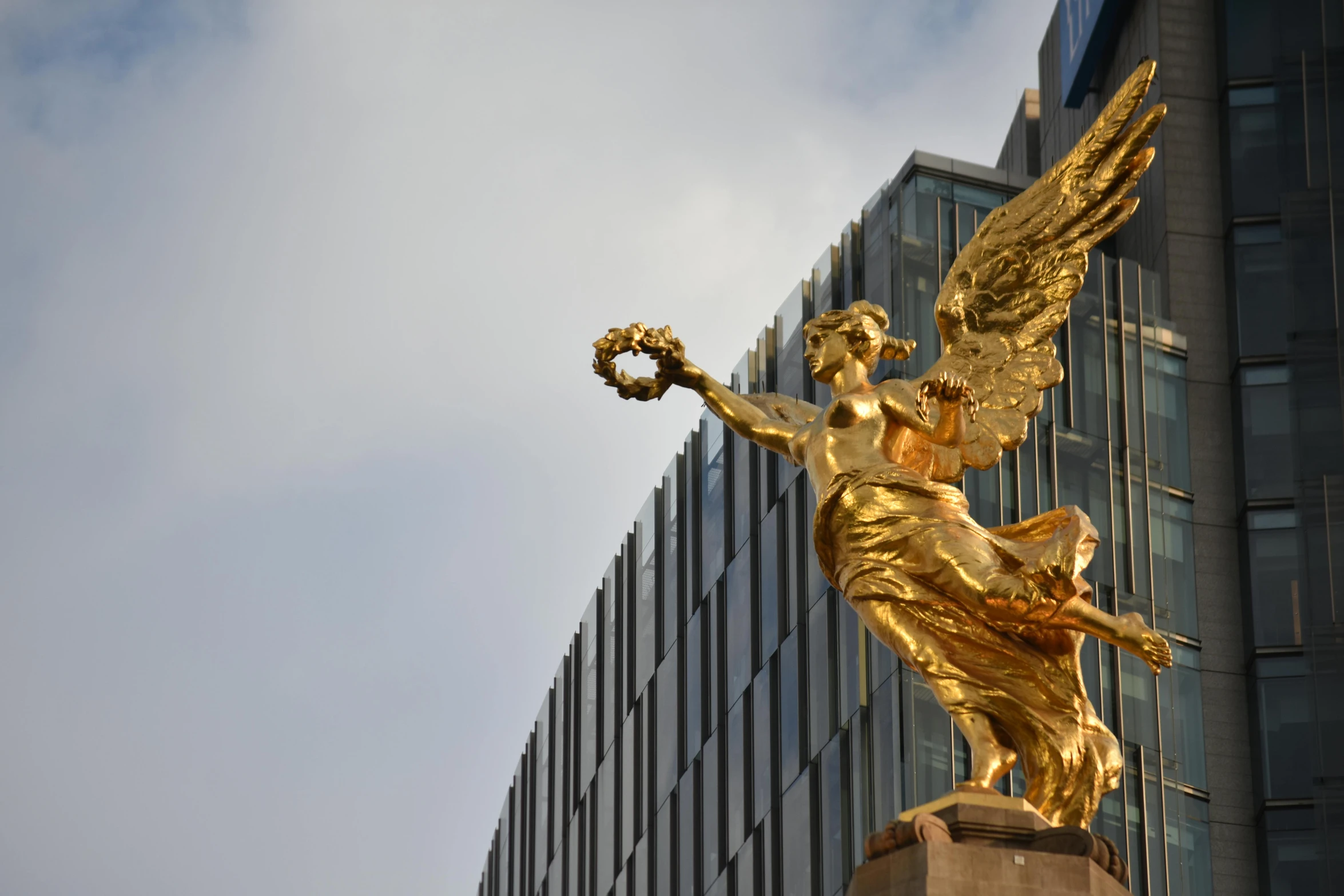 a statue of an angel with a ribbon in hand